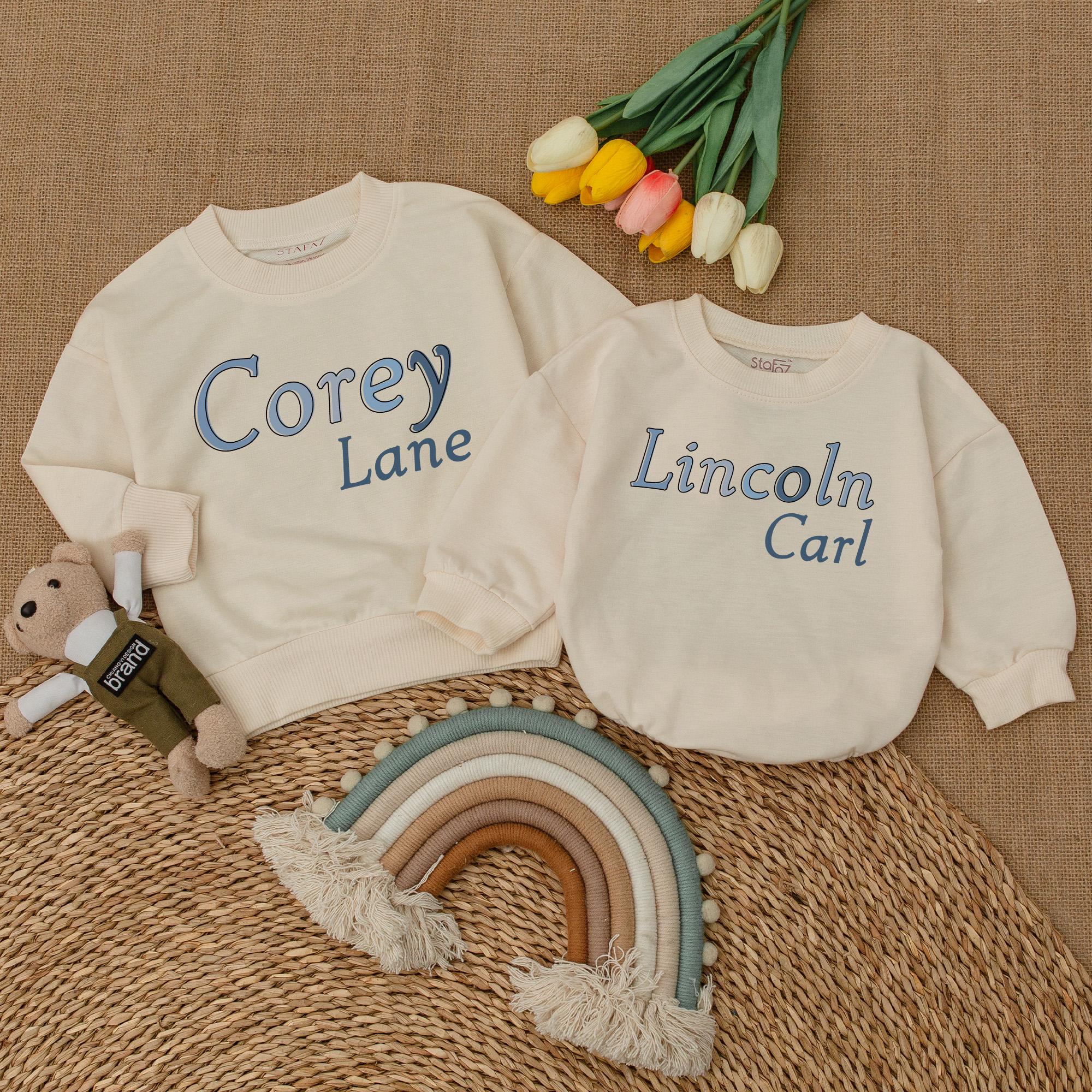 Personalized Name Boy Bubble Romper Big Brother Sweatshirt Matching Sibling Family Clothes Soft Blue Text Cream Background Baby Outfit