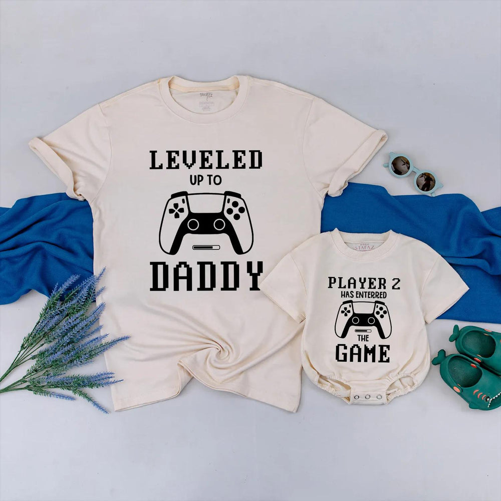 Matching Gamer Shirts for Dad and Baby with Pixelated Text Design New Dad Gift Leveled Up to Daddy and Player 2 Father's Day Outfit