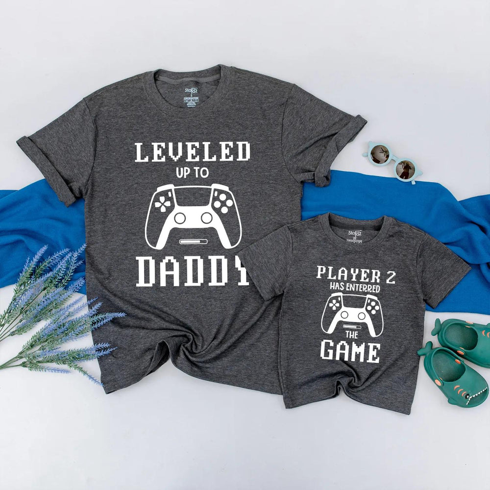 Matching Gamer Shirts for Dad and Baby with Pixelated Text Design New Dad Gift Leveled Up to Daddy and Player 2 Father's Day Outfit
