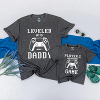 Matching Gamer Shirts for Dad and Baby with Pixelated Text Design New Dad Gift Leveled Up to Daddy and Player 2 Father's Day Outfit