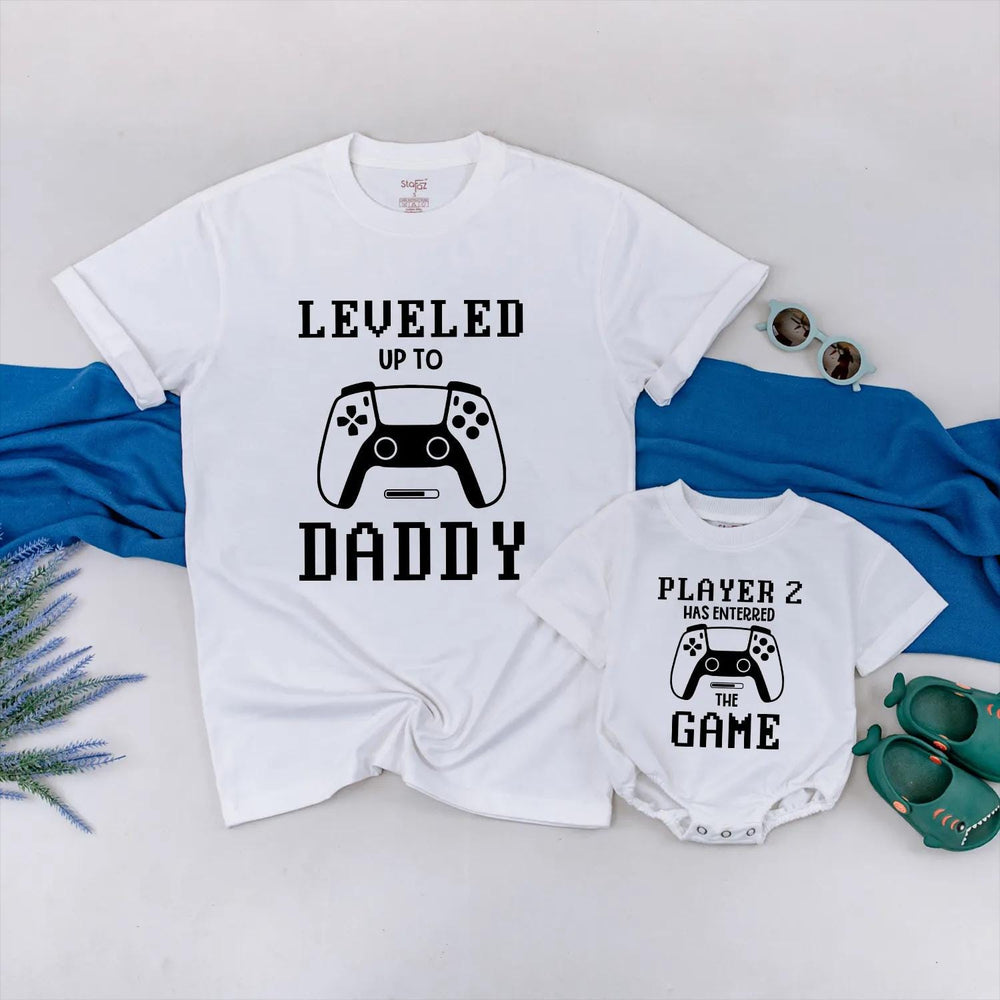 Matching Gamer Shirts for Dad and Baby with Pixelated Text Design New Dad Gift Leveled Up to Daddy and Player 2 Father's Day Outfit