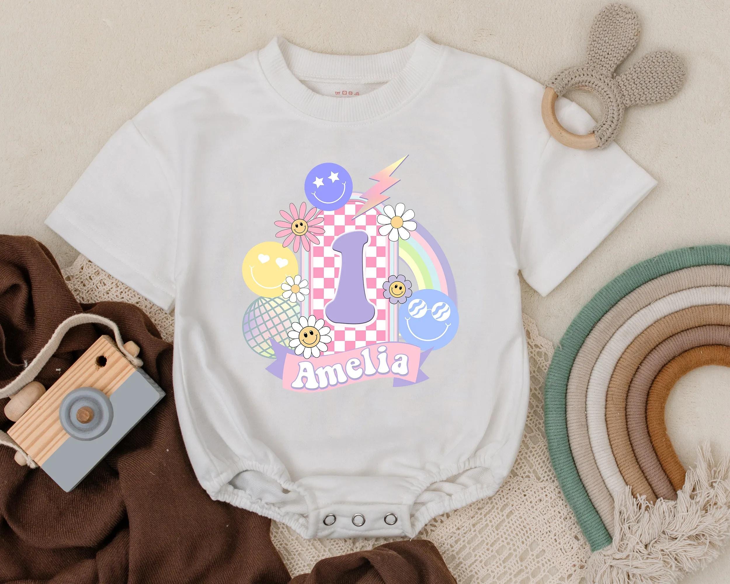 Personalized Baby Girl Birthday Romper with Retro Number 1 Pink Checkered Fun Outfit for First Celebration with Smiley Faces and Balloons