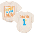 Personalized One in the Sun First Birthday Boy Romper with Cartoon Sun Design Bright Blue and Orange Party Outfit Name and Age Gift